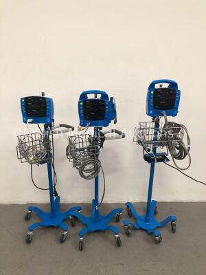 2 x GE Carescape V100 Patient Monitors on Stands with 1 x BP Hose and 1 x SpO2 Finger Sensor and 1 x GE Dinamap ProCare 400 Patient Monitor on Stand w