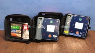 2 x Philips Heartstart FR2+ Defibrillators in Carry Cases with 2 x Batteries *Install Dates 10-2021 / 09-2023* (Both Power Up and Pass Self Test) *010