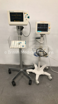 1 x Philips SureSigns VS3 Patient Monitor on Stand with SPO2 Finger Sensor and 1 x Datex-Ohmeda S/5 Patient Monitor on Stand (Both Power Up)