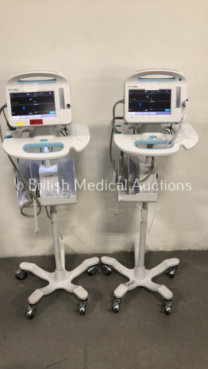 2 x Welch Allyn 6000 Series Patient Monitors on Stands with SPO2, BP and Temp Options and Leads (Both Power Up)