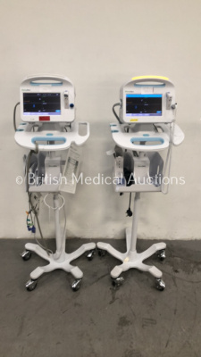 2 x Welch Allyn Vital Signs Monitors 6000 Series on Stands with 2 x BP Hoses and 1 x SpO2 Finger Sensor (Both Power Up)