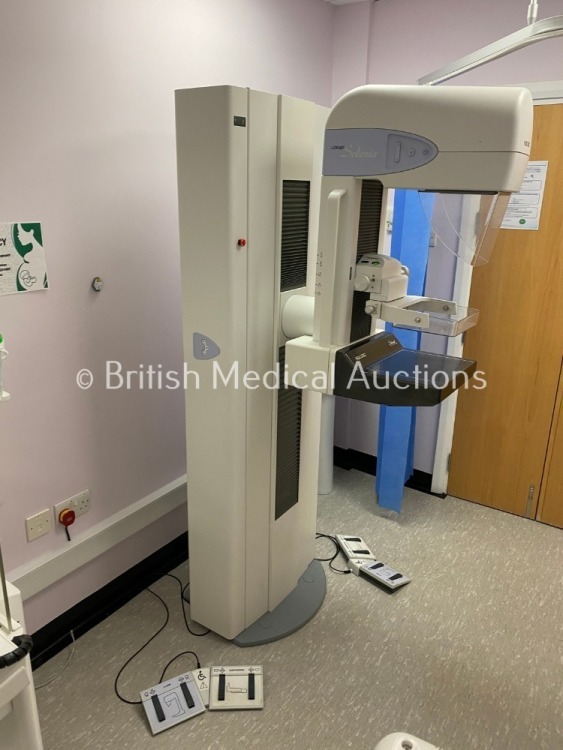 Hologic Lorad Selenia Mammography System *Mfd - 2008* Fully Operational Prior to Professional Deinstallation and Includes: Gantry, Console table with Screen, PC & Monitor and Cables. (Slight Damage to Casing - See Photo) For Further Information please Con