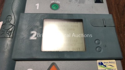 1 x Laerdal Heartstart FR and 1 x Hewlett Packard Heartstream Semi Automatic Defibrillators with 1 x Battery and 1 x Carry Case (Both Power Up and Pas - 3