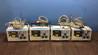 4 x Zoll M Series Defibrillators with Pacer and ECG Options with 4 x Paddle Leads, 4 x 3 Lead ECG Leads and 4 x Batteries (All Power Up When Plugged i
