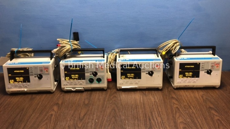 4 x Zoll M Series Defibrillators Including 1 x Pacer and 4 x ECG Options with 4 x Paddle Leads, 4 x 3 Lead ECG Leads and 4 x Batteries (All Power Up)