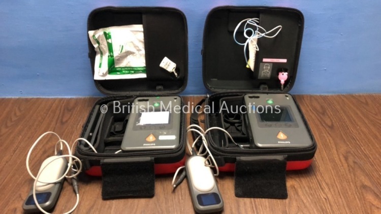 2 x Philips Heartstart FR3 Defibrillators in Cases with 1 x Battery and 2 x QCPR Meters (Both Power Up) *C16E-01078 / C14F-01177* (H)