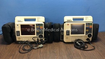 2 x Medtronics Lifepak 12 12-Lead Defibrillators, 1 with SPO2, ECG and Printer Options and 1 with CO2, SPO2, NIBP and CO2 Options and 2 x Paddle Leads (Both Power Up with Stock Battery, 1 with Service Light, Battery Not Included)