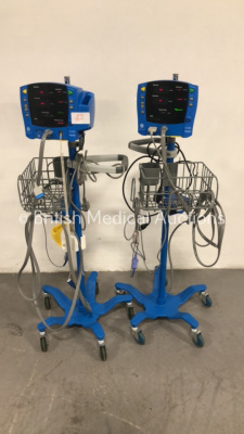 2 x GE Dinamap Carescape V100 Vital Signs Monitors on Stands with SPO2 Finger Sensors and BP Hoses (Both Power Up)