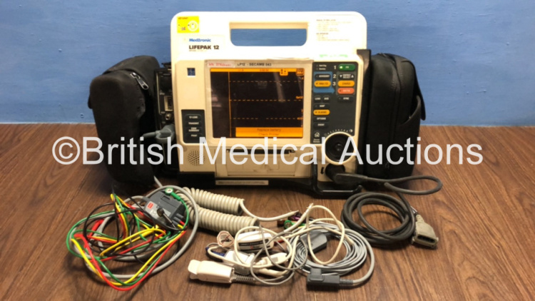 Medtronic Lifepak 12 12- Lead Defibrillator / Monitor Including ECG, SpO2, C02, NIBP and Printer Options with 2 x Batteries, 2 x ECG Lead, 1 x Sp02 Lead with Finger Sensor, 1 x NIBP Lead, 1 x Paddle Lead and Storage Pack *Mfd 2009* (Powers Up) *376202876*