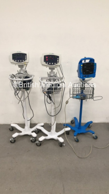 2 x Welch Allyn 53NT0 Vital Signs Monitors on Stands with BP Hoses, Cuffs and SPO2 Finger Sensors and 1 x GE ProCare Auscultatory Vital Signs Monitor on Stand (All Power Up) *S/N JA112788 / JA110820*