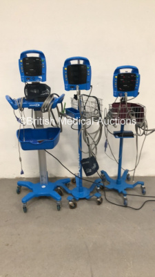 2 x GE ProCare Auscultatory 300 Vital Signs Monitors on Stands with 2 x BP Hose and 1 x SPO2 Finger Sensor and 1 x GE ProCare Auscultatory Vital Signs Monitor on Stand with BP Hose and SPO2 Finger Sensor (1 x Powers Up - 1 x Powers Up with Alarm and 1 x N