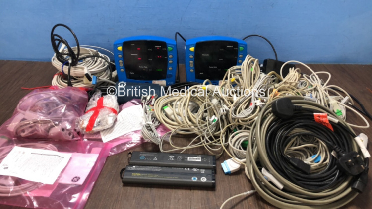 Mixed Lot Including 2 x GE V100 Dinamap Patient Monitors with 2 x AC Power Supplies (Both Power Up) 2 x GE Model SM 201-6 Batteries (Both With Full Power) Large Quantity of Various Patient Monitoring Cables Such as ECG Leads, SpO2 Finger Sensors and BP Ho