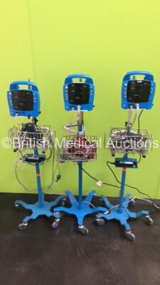 3 x GE Dinamap ProCare Patient Monitors on Stands with 3 x SpO2 Finger Sensors,3 x BP Hoses and 3 x BP Cuffs (All No Power)