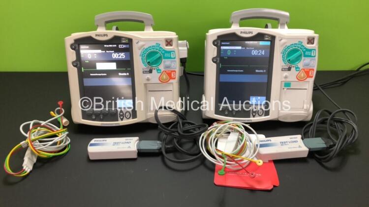 2 x Philips Heartstart MRx Defibrillators Including Pacer, ECG and Printer Options with 2 x Philips M3539A Batteries, 2 x Philips M3538 Module, 2 x Paddle Leads with Test Loads *Mfd 2008 / 2011* (Both Power Up)