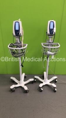 2 x Welch Allyn Spot Vital Signs Monitors on Stands with 2 x BP Hoses and 1 x SpO2 Finger Sensor (Both Power Up- 1 x Damage to Mounting Bracket-See Photo)