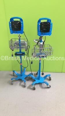 2 x GE ProCare Vital Signs Monitors on Stands (Both Power Up - 1 x Missing Wheel)
