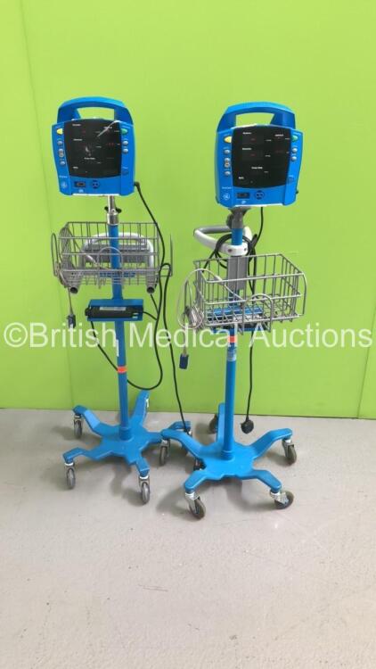 2 x GE ProCare Vital Signs Monitors on Stands (Both Power Up - 1 x Missing Wheel)