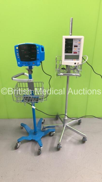 1 x Datascope Accutorr Plus Patient Monitor on Stand with 1 x BP Hose and 1 x GE Carescape V100 Dinamap Patient Monitor on Stand (Both Power Up)