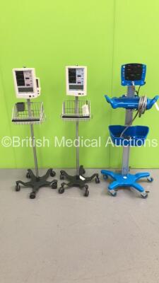 2 x Datascope Accutorr Plus Patient Monitors on Stands and 1 x GE Carescape V100 Patient Monitor on Stand (All Power Up) * SN SH618490018SA - A716777-B1 - A722117-E2 *