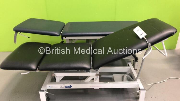 1 x Medi Plinth 3-Way Electric Patient Examination Couch with Controller and 1 x Huntleigh Akron Hydraulic Patient Examination Couch (Powers Up,Hydraulics Tested Working-Damage to Cushions-See Photos) * Asset No FS 0021501 / FS0179688 *