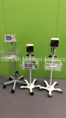 2 x Criticare 506DXN Patient Monitors on Stands with 1 x BP Hose,1 x BP Cuff and 1 x Nellcor Puritan Bennett Patient Monitor on Stand (All Power Up)