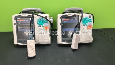 2 x Philips MRx Defibrillators Including ECG and Printer Options with 2 x Philips M3538A Batteries and 2 x Philips M3539A Modules, 2 x Paddle Leads and 2 x Philips M3725A Test Loads (Both Power Up)