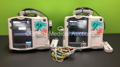 2 x Philips MRx Defibrillators Including Pacer, ECG and Printer Options with 2 x Philips M3538A Batteries, 2 x Philips M3539A Modules, 1 x ECG Lead, 2 x Paddle Leads and 2 x Philips M3725A Test Loads (Both Power Up)