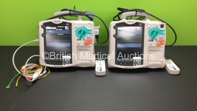 2 x Philips MRx Defibrillators Including Pacer, ECG and Printer Options with 2 x Philips M3538A Batteries, 2 x Philips M3539A Modules, 1 x ECG Lead, 2 x Paddle Leads and 2 x Philips M3725A Test Loads (Both Power Up)