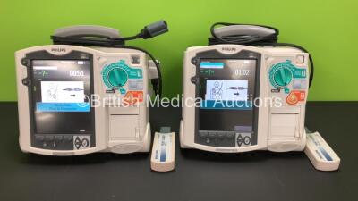 2 x Philips Heartstart MRx Defibrillators Including ECG and Printer Options with 2 x Paddle Leads and 2 x Philips M3725A Test Loads 2 x M3539A Modules and 2 x Philips M3538A Batteries *Mfd 2011 - 2008* (Both Power Up)