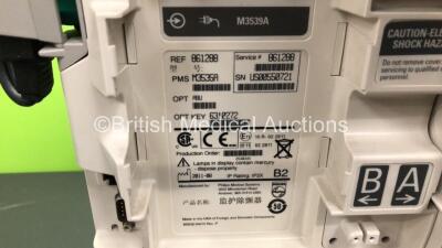 2 x Philips Heartstart MRx Defibrillators Including ECG and Printer Options with 2 x Paddle Leads and 2 x Philips M3725A Test Loads, 1 x QCPR Meter, 2 x M3539A Modules and 2 x Philips M3538A Batteries *Mfd 2011 - 2011* (Both Power Up) - 5