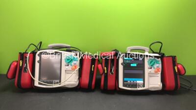 2 x Philips MRx Defibrillators Including Pacer, ECG and Printer Options with 2 x Philips M3538A Batteries, 2 x Philips M3539A Modules, 2 x Paddle Leads, 2 x Philips M3725A Test Loads and 2 x Carry Bags (Both Power Up) *SN US00329921 - US00533145*