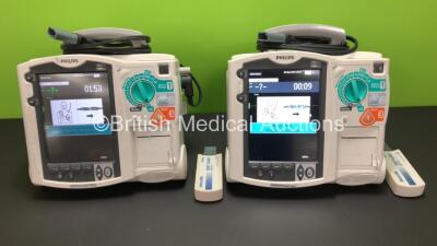 2 x Philips Heartstart MRx Defibrillators Including ECG and Printer Options with 2 x Paddle Leads and 2 x Philips M3725A Test Loads 2 x M3539A Modules and 2 x Philips M3538A Batteries *Mfd 2011 - 2011* (Both Power Up)