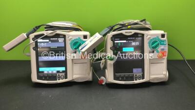 2 x Philips MRx Defibrillators Including Pacer, ECG and Printer Options with 2 x Philips M3538A Batteries, 2 x Philips M3539A Modules, 2 x Paddle Leads, 2 x 3 Lead ECG Leads and 2 x Philips M3725A Test Loads (Both Power Up) *SN US00563581 - US00554108*