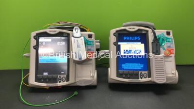 2 x Philips MRx Defibrillators Including Pacer, ECG and Printer Options with 2 x Philips M3538A Batteries, 2 x Philips M3539A Modules, 2 x Paddle Leads, 2 x 3 Lead ECG Leads and 2 x Philips M3725A Test Loads (Both Power Up) *SN US00563581 - US00554108*