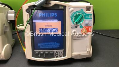 2 x Philips MRx Defibrillators Including Pacer, ECG and Printer Options with 2 x Philips M3538A Batteries, 2 x Philips M3539A Modules, 2 x Paddle Leads and 2 x 3 Lead ECG Leads (Both Power Up) *SN US00329924 - US00329922* - 2