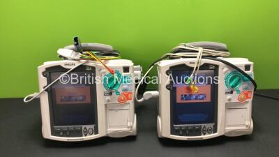 2 x Philips MRx Defibrillators Including Pacer, ECG and Printer Options with 2 x Philips M3538A Batteries, 2 x Philips M3539A Modules, 2 x Paddle Leads and 2 x 3 Lead ECG Leads (Both Power Up) *SN US00329918 - US00534792*