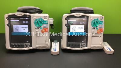 2 x Philips Heartstart MRx Defibrillators Including ECG and Printer Options with 2 x Paddle Leads and 2 x Philips M3725A Test Loads 2 x M3539A Modules and 2 x Philips M3538A Batteries *Mfd 2008 - 2008* (Both Power Up)