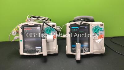 2 x Philips MRx Defibrillators Including Pacer, ECG and Printer Options with 2 x Philips M3538A Batteries, 2 x Philips M3539A Modules, 2 x Paddle Leads, 2 x 3 Lead ECG Leads and 2 x Philips M3725A Test Loads (Both Power Up) *SN US00322226 - US00534791*
