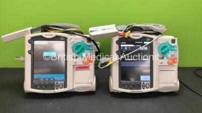2 x Philips MRx Defibrillators Including Pacer, ECG and Printer Options with 2 x Philips M3538A Batteries, 2 x Philips M3539A Modules, 2 x Paddle Leads, 2 x 3 Lead ECG Leads and 2 x Philips M3725A Test Loads (Both Power Up) *SN US00214825 - US00557257*