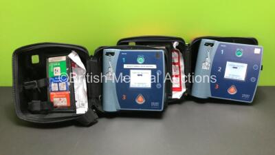 2 x Philips Heartstart FR2+ Defibrillators in Carry Cases with 2 x Batteries *Install Dates 12-2022 / 10-2021* (Both Power Up and Pass Self Test) *1011890076 - 0206183568*