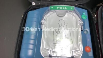 3 x Philips Heartstart HS1 Defibrillators with 3 x Carry Cases and 3 x Batteries (All Power Up) *A09F 03140 - A09F 03138 - A09F 03124* - 2