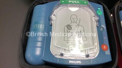 3 x Philips Heartstart HS1 Defibrillators with 3 x Carry Cases and 3 x Batteries (All Power Up) *A09F 03141 - A11D 05898 - A09J 04458* - 2