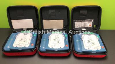 3 x Philips Heartstart HS1 Defibrillators with 3 x Carry Cases and 3 x Batteries (All Power Up) *A09F 03148 - A09F 03056 - A09L 00143*