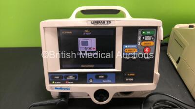 2 x Medtronic Lifepak 20 Defibrillator / Monitors with ECG and Printer Options, 2 x Paddle Leads and 2 x 3 Lead ECG Leads (Both Power Up with Missing Panel Doors-See Photos) - 2