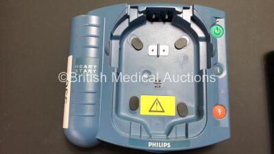 Job Lot Including 1 x Philips HeartStart FR2+ Defibrillator (Powers Up and Passes Self Test with Stock Battery - Some Damage to Display - See Photo) 1 x Laerdal HeartStart FR2+ Defibrillator (Powers Up Failing Self Test) 1 x Philips M3863A Battery (Flat) - 4