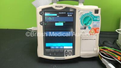 2 x Philips MRx Defibrillators Including Pacer, ECG and Printer Options with 2 x Philips M3538A Batteries, 2 x Philips M3539A Modules, 2 x Paddle Leads and 2 x 3 Lead ECG Leads (Both Power Up) *SN US0032223768 - US00322235 - 307713 - 307720* - 2