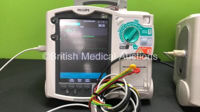 2 x Philips MRx Defibrillators Including Pacer, ECG and Printer Options with 2 x Philips M3538A Batteries, 2 x Philips M3539A Modules, 2 x Paddle Leads, 2 x Philips M3725A Test Loads and 2 x 3 Lead ECG Leads (Both Power Up) *SN US00332946 - US00214824* - 2