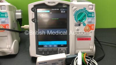 2 x Philips MRx Defibrillators Including Pacer, ECG and Printer Options with 2 x Philips M3538A Batteries, 2 x Philips M3539A Modules, 2 x Paddle Leads, 2 x Philips M3725A Test Loads and 2 x 3 Lead ECG Leads (Both Power Up) *SN US00332946 - US00214824* - 3