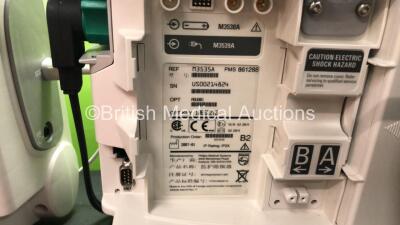 2 x Philips MRx Defibrillators Including Pacer, ECG and Printer Options with 2 x Philips M3538A Batteries, 2 x Philips M3539A Modules, 2 x Paddle Leads, 2 x Philips M3725A Test Loads and 2 x 3 Lead ECG Leads (Both Power Up) *SN US00332946 - US00214824* - 6