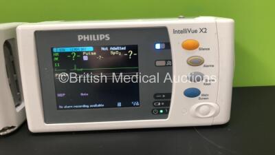 2 x Philips IntelliVue X2 Patient Monitors with Press, Temp, NBP, SPO2 and ECG Resp Options and 2 x Batteries *Mfds - 1 x 2010, 1 x Missing Label* (Both Power Up, 1 Missing Battery Cover and Damaged Casing - See Photos) - 2